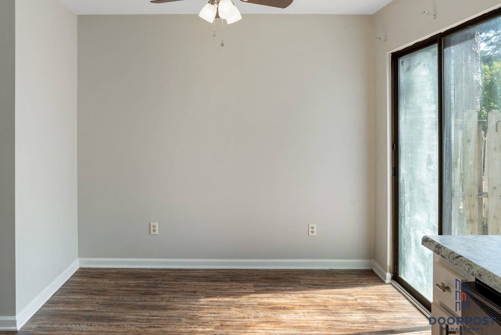 a living room with a large window and wood floors