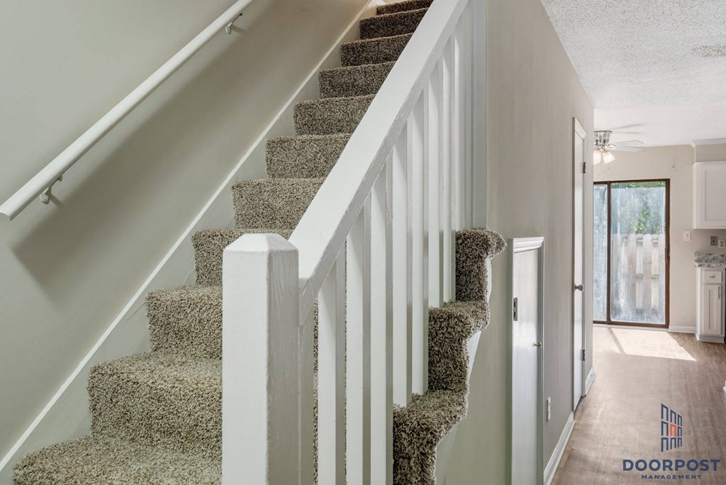 a view of the stairs in a home with carpeted stairs