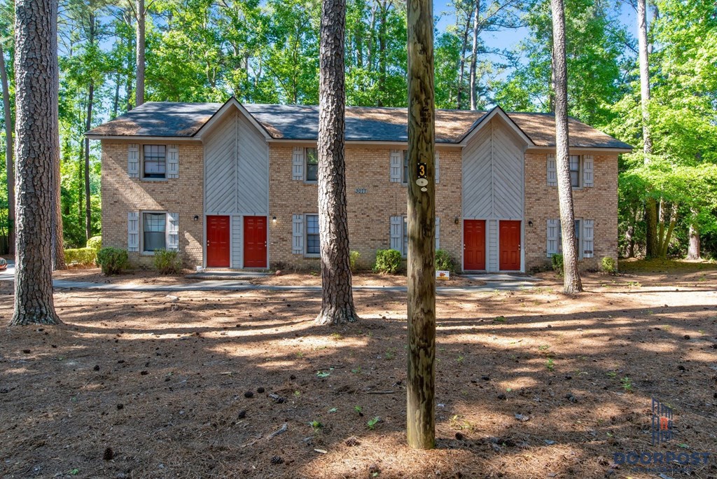 a house with red doors in the woods
