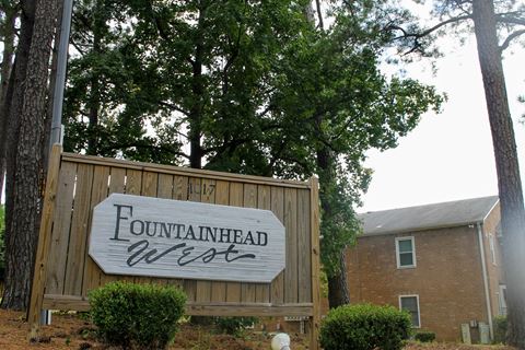 a sign for the fountainhead west in front of a building