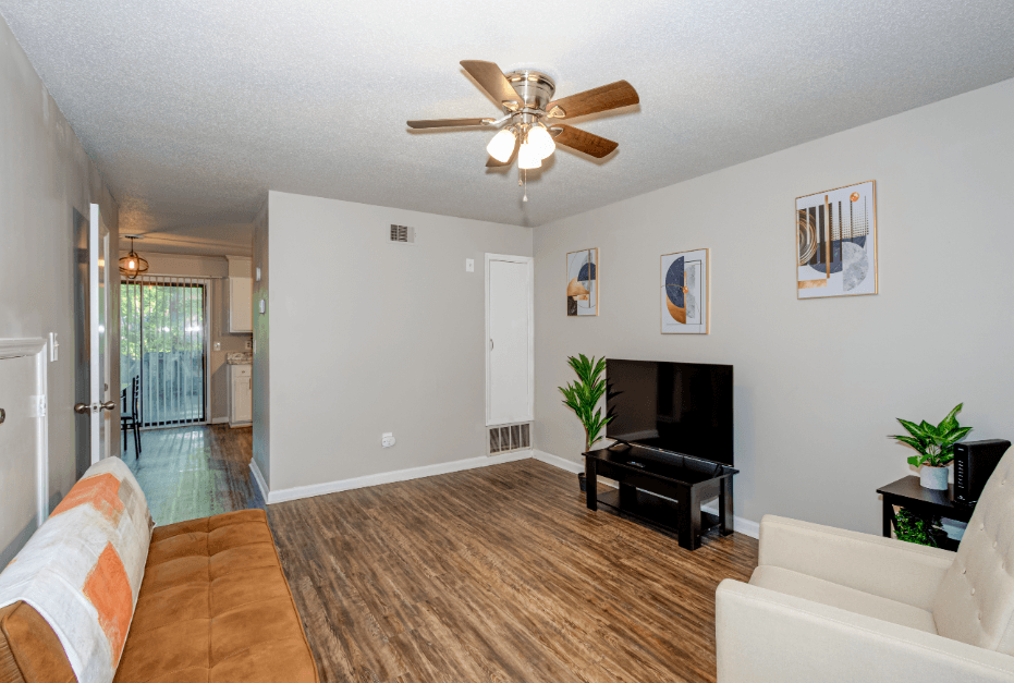 a living room with a couch and a ceiling fan