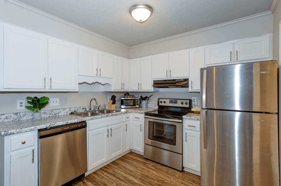 a kitchen with stainless steel appliances and white cabinets