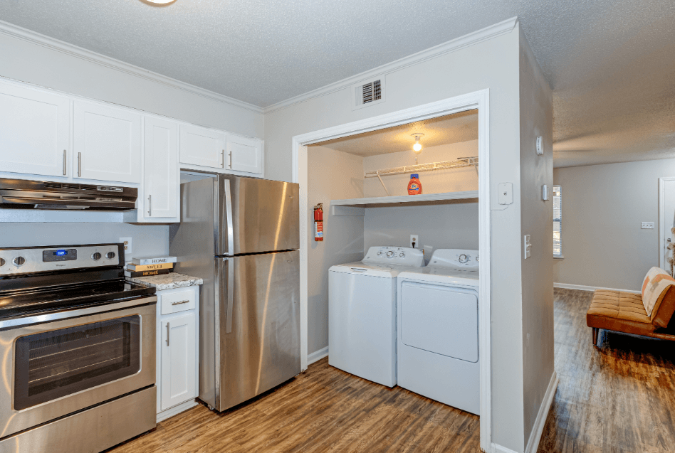 a kitchen with stainless steel appliances and white cabinets