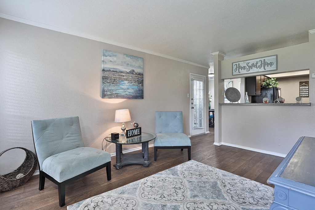 a living room with two chairs and a table