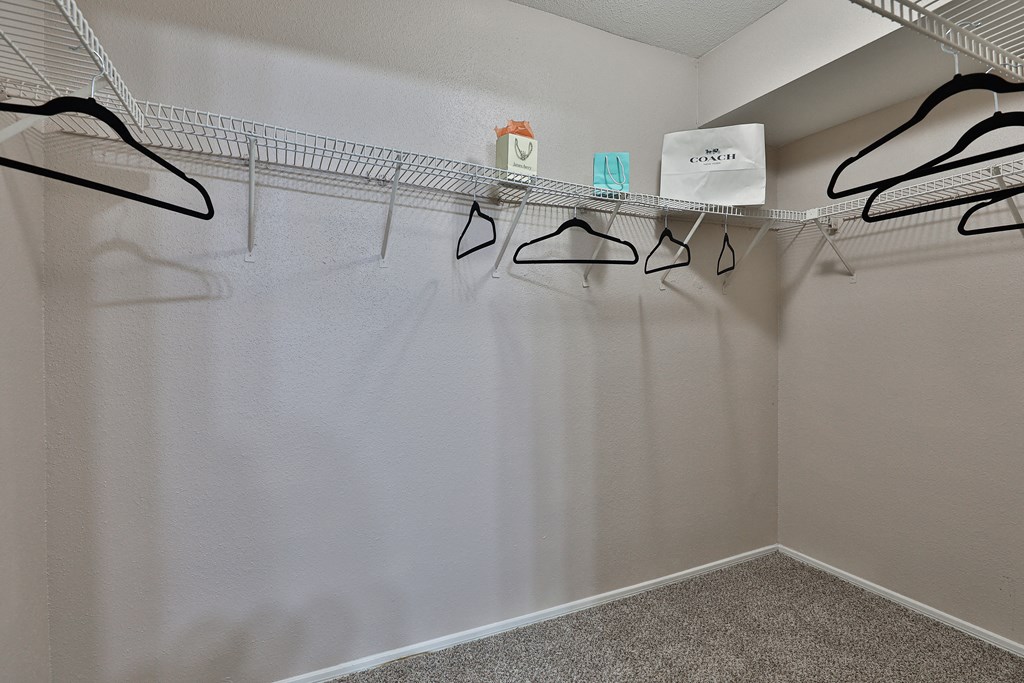 an empty closet with eyeglasses hanging on the wall