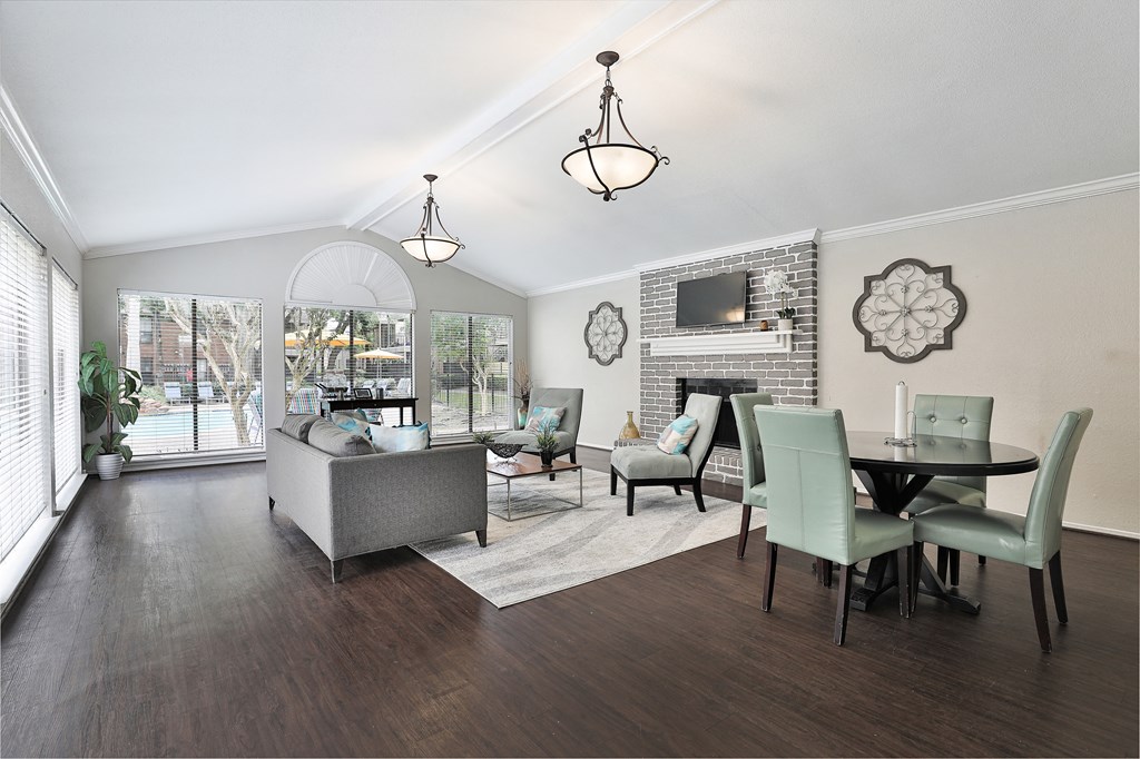 a living room and dining room with a table and chairs