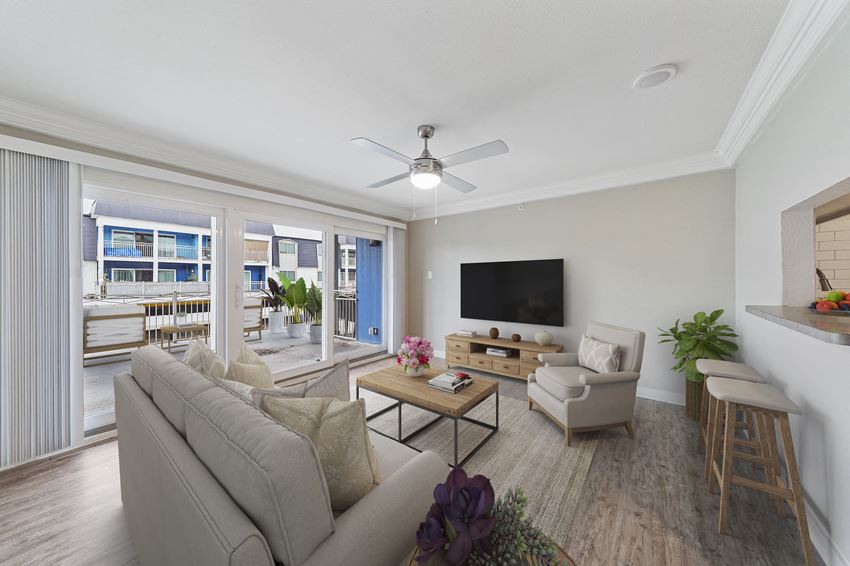a living room with a ceiling fan and a couch