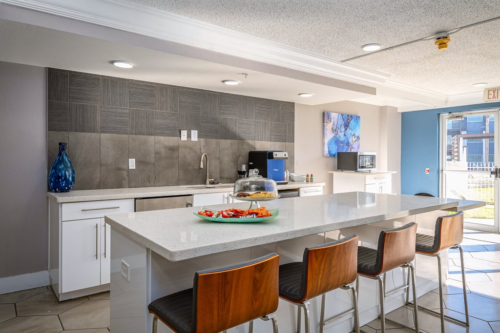 a kitchen with a large island and bar stools