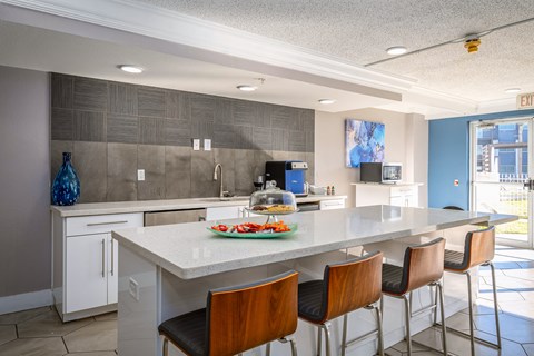 a kitchen with a large island and bar stools