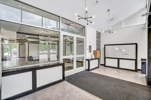 A modern office space with a reception desk and a calendar on the wall.
