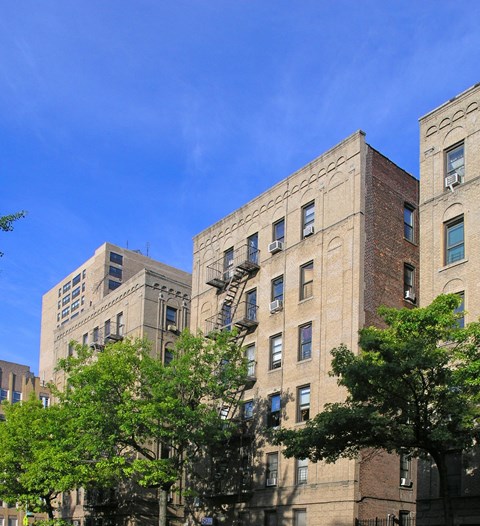 A tall building with a fire escape on the side.