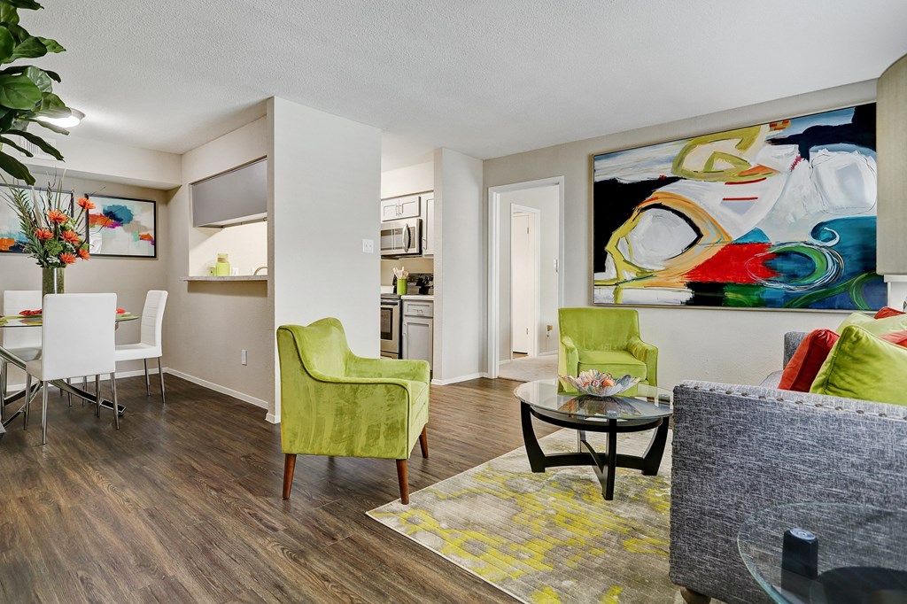 a living room and dining room with a table and chairs