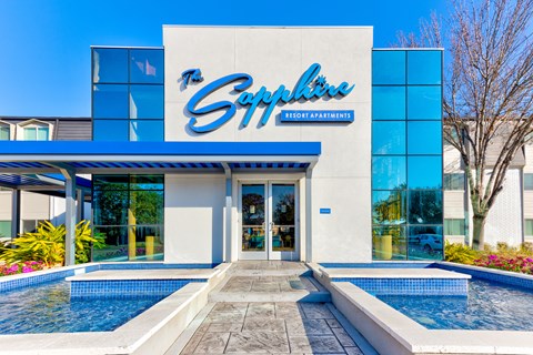 the exterior of the sap office building with pools and a blue and white sign