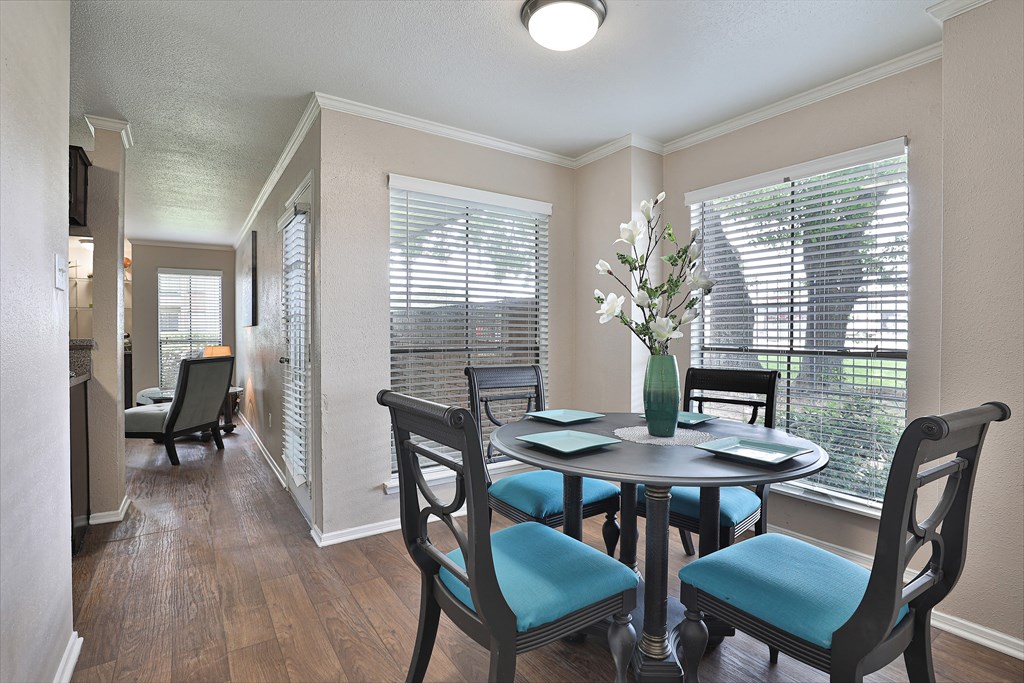 a dining room with a table and chairs and a window