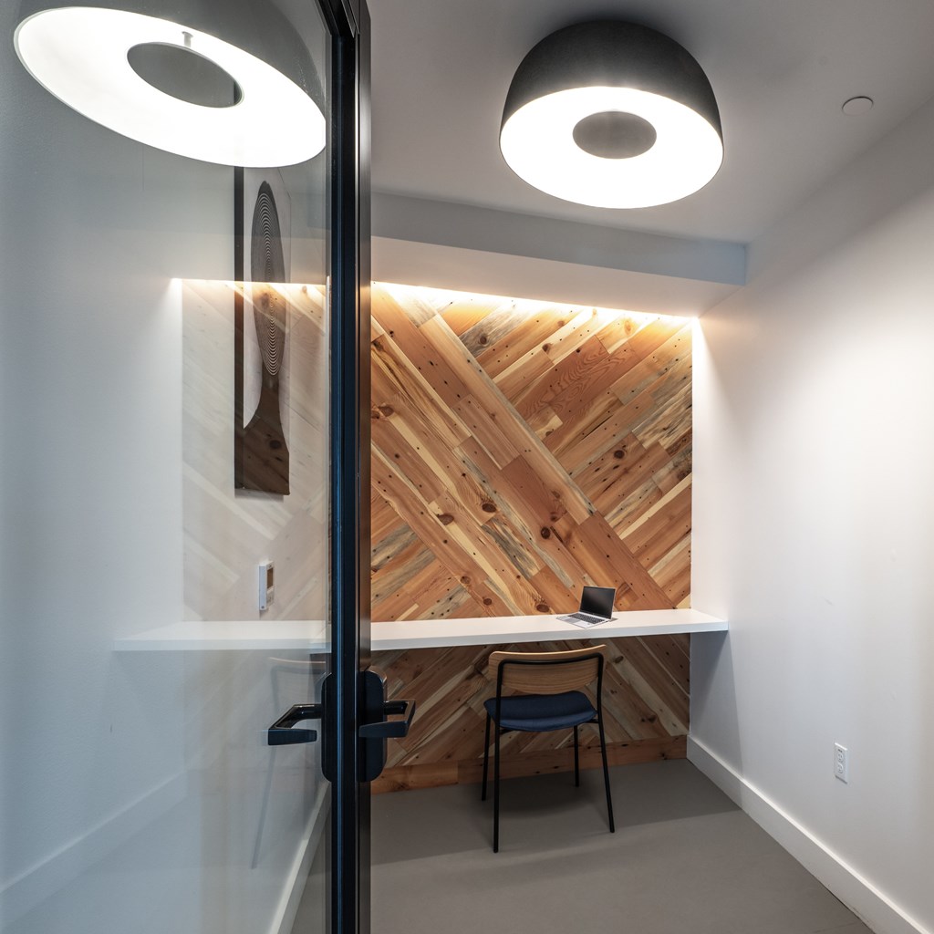 A wooden wall with a table and chair in front of it.