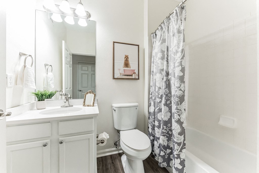 a white bathroom with a shower curtain and a toilet  at Cumberland Crossing, Cumberland, Rhode Island