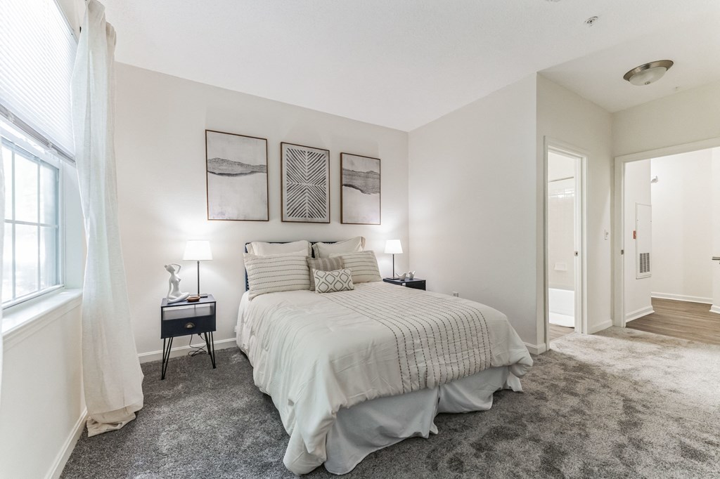 a bedroom with a large bed and a window  at Cumberland Crossing, Cumberland, Rhode Island