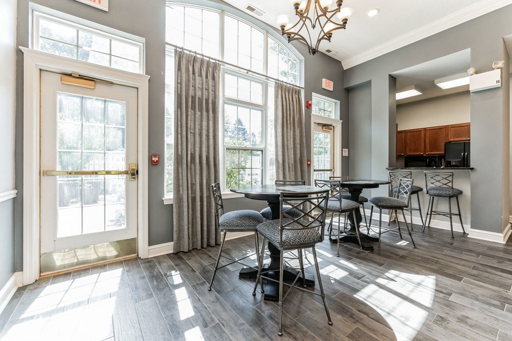 a dining room with tables and chairs and large windows at Cumberland Crossing, Cumberland, 02864