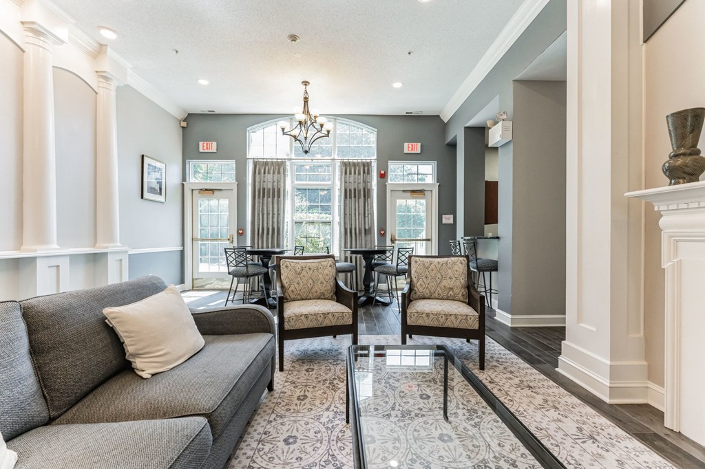 a living room with a couch and a glass table  at Cumberland Crossing, Cumberland, 02864