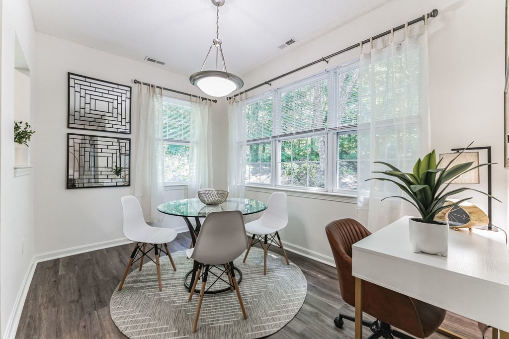 a dining room with a table and chairs and a window  at Cumberland Crossing, Rhode Island
