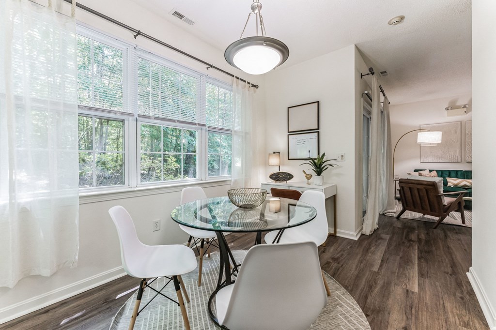 a dining room with a glass table and chairs  at Cumberland Crossing, Cumberland, 02864