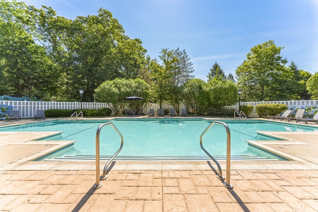 a swimming pool with trees and a white fence around it  at Cumberland Crossing, Cumberland, RI, 02864