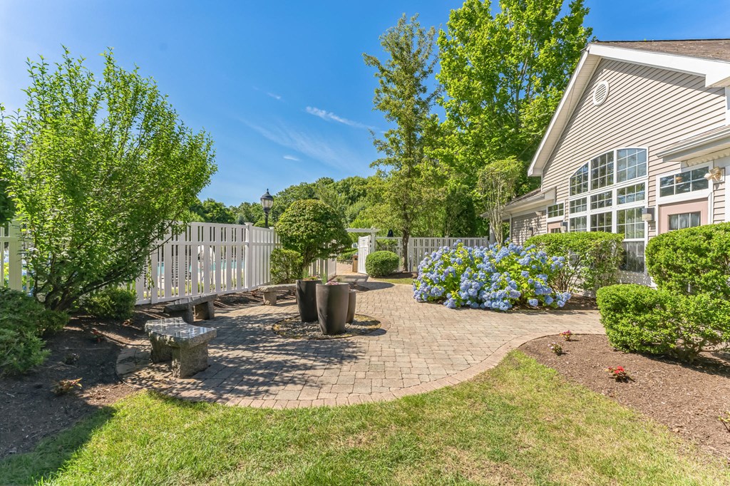 a backyard with a patio and trees and a house  at Cumberland Crossing, Rhode Island