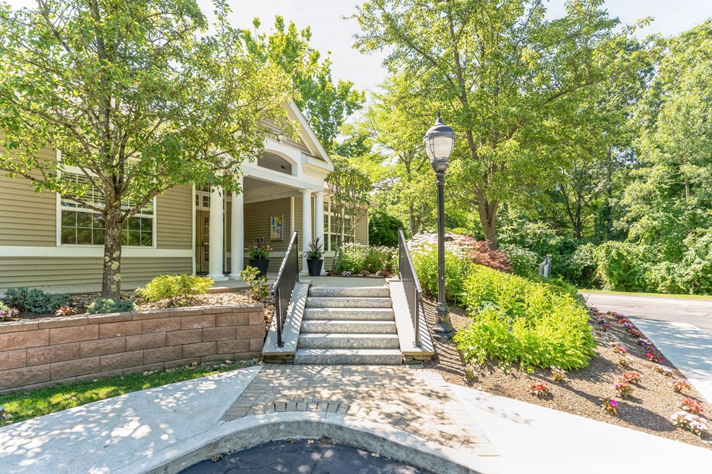 a front porch with stairs and a house with trees  at Cumberland Crossing, Cumberland, RI, 02864