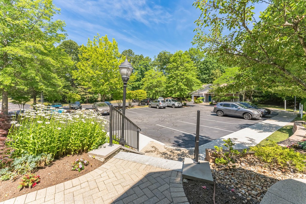a parking lot with cars in it and trees at Cumberland Crossing, Cumberland, 02864