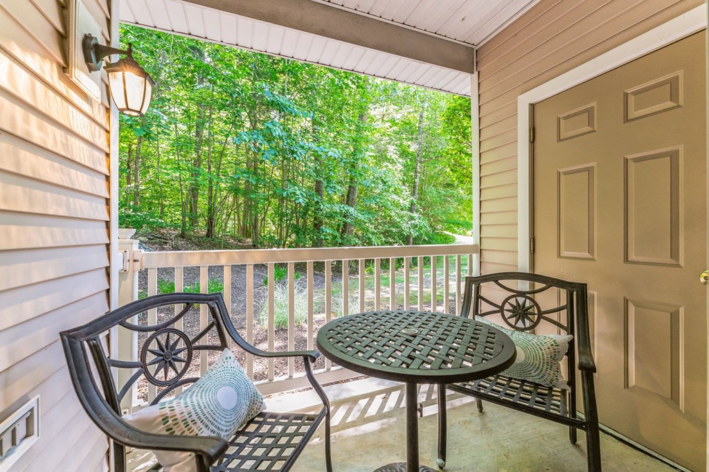 a patio with a table and chairs on a porch  at Cumberland Crossing, Rhode Island, 02864