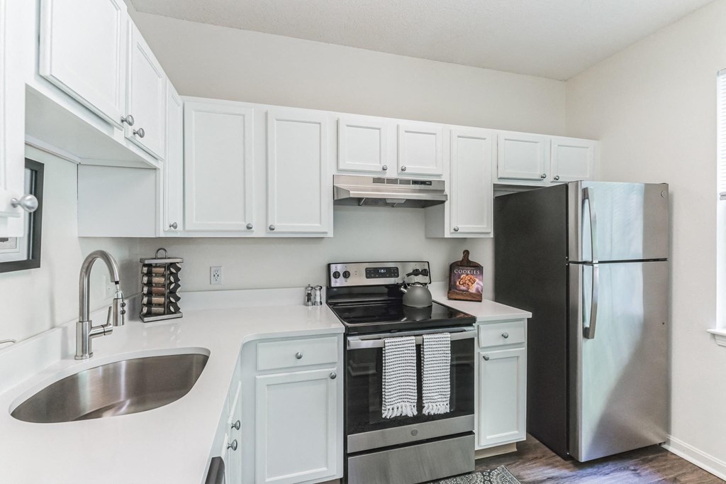a white kitchen with stainless steel appliances and white cabinets  at Cumberland Crossing, Rhode Island, 02864