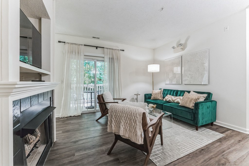 living room with a fireplace and a green couch at Cumberland Crossing, Cumberland, 02864
