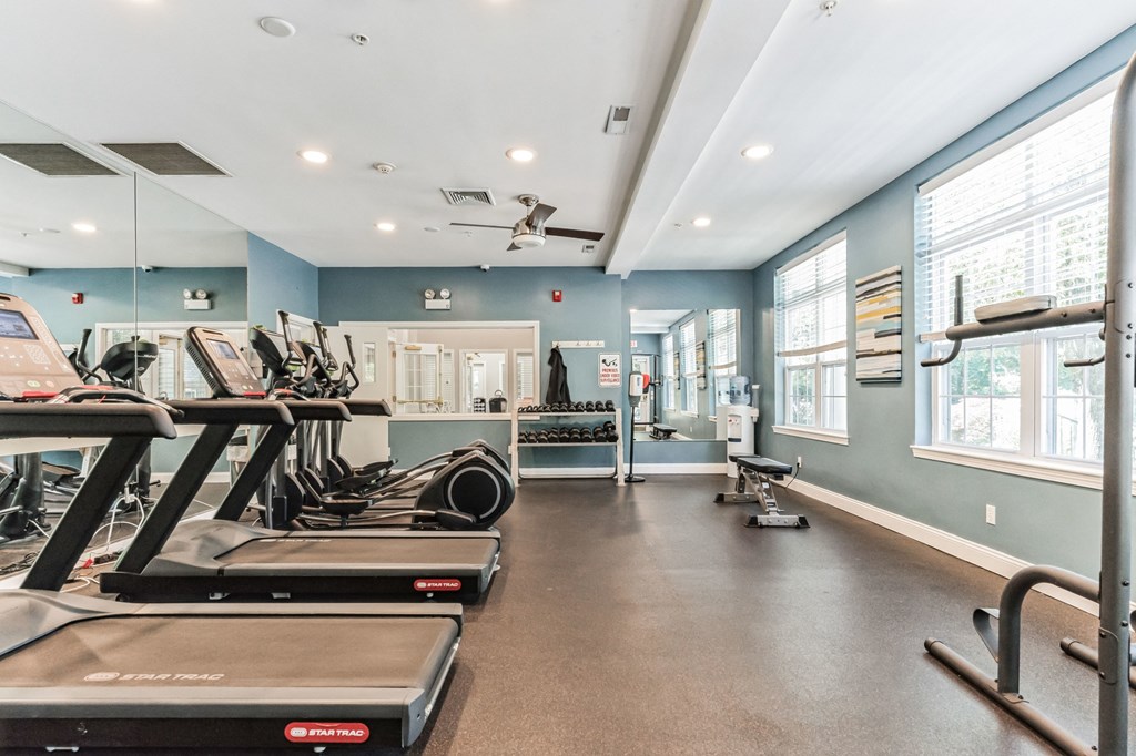 a gym with treadmills and other exercise equipment and windows  at Cumberland Crossing, Cumberland, 02864