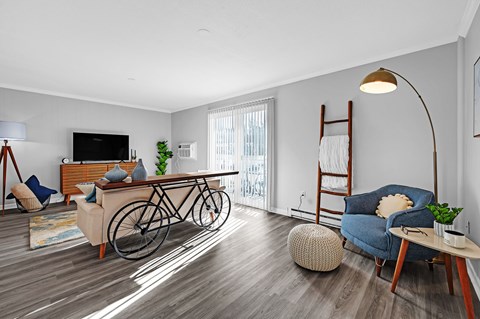 A living room with a bicycle leaning against the wall.