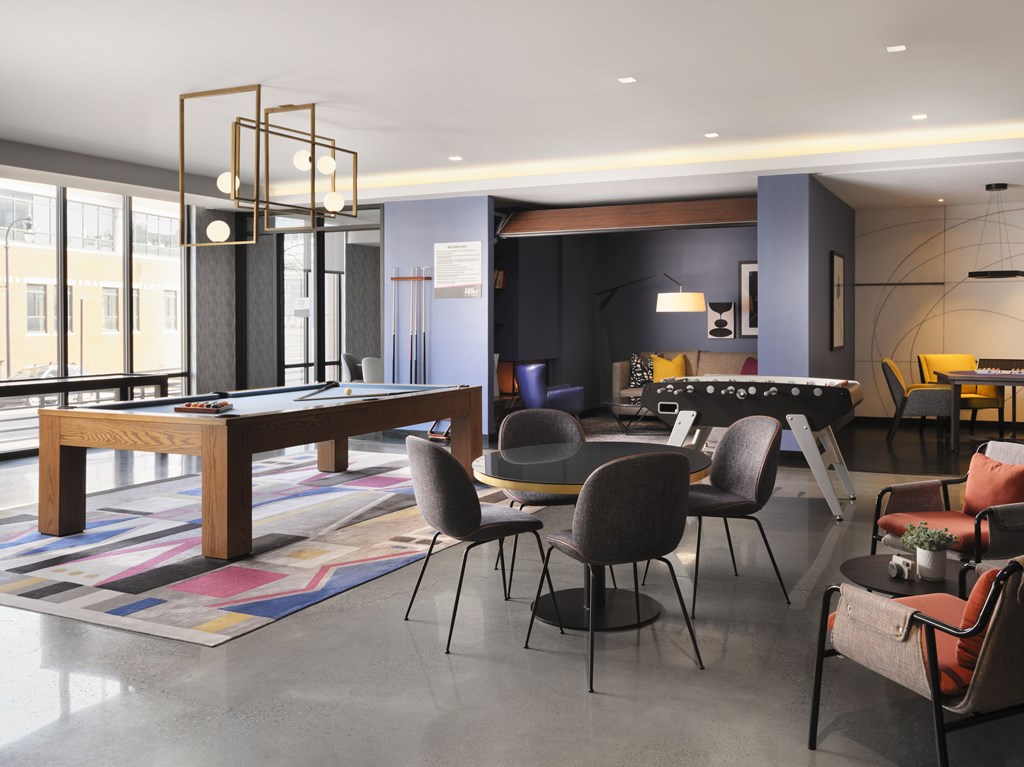 A modern dining room with a large table and chairs.