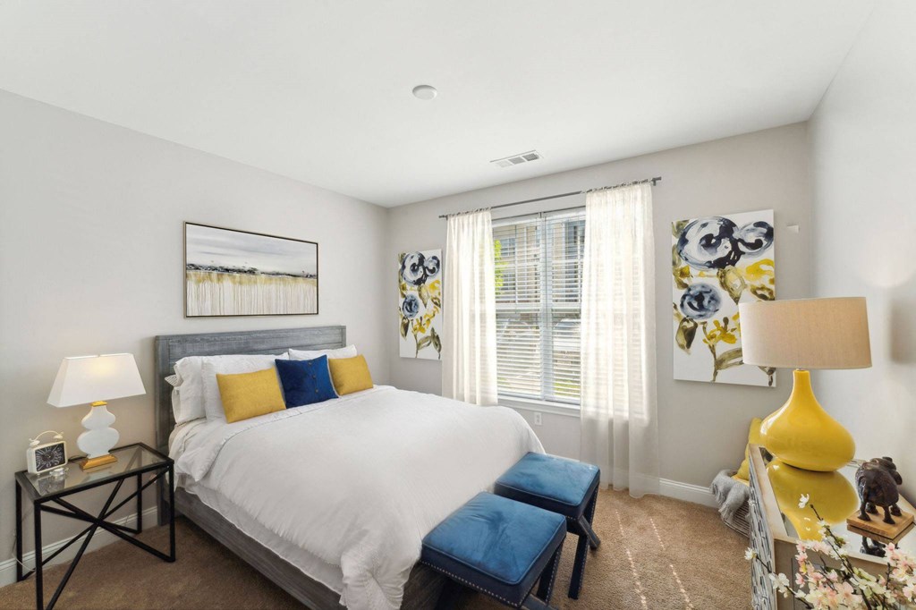 a bedroom with a large bed and a window