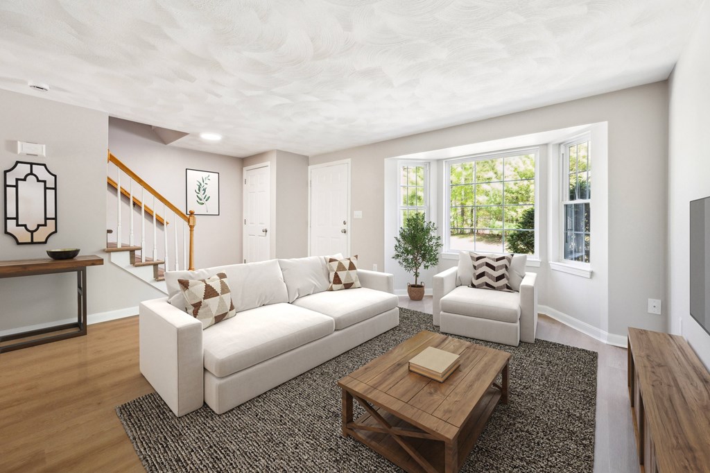 A living room with a white couch and a coffee table.