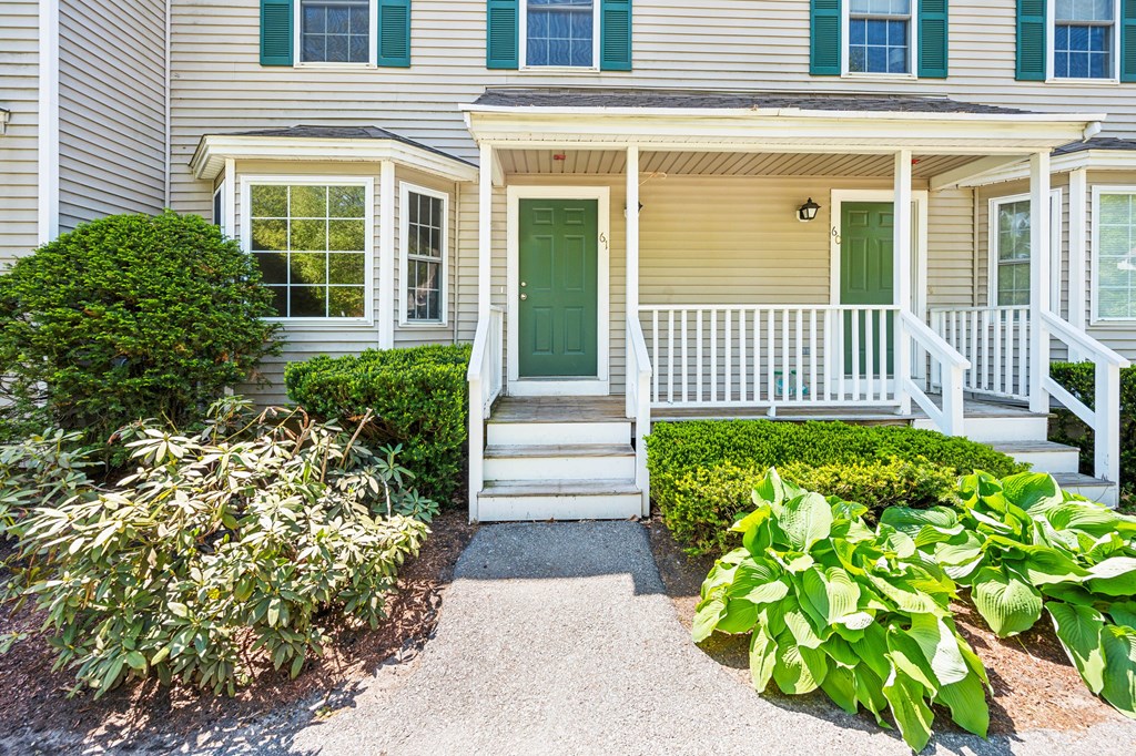 A house with a green door and white windows.