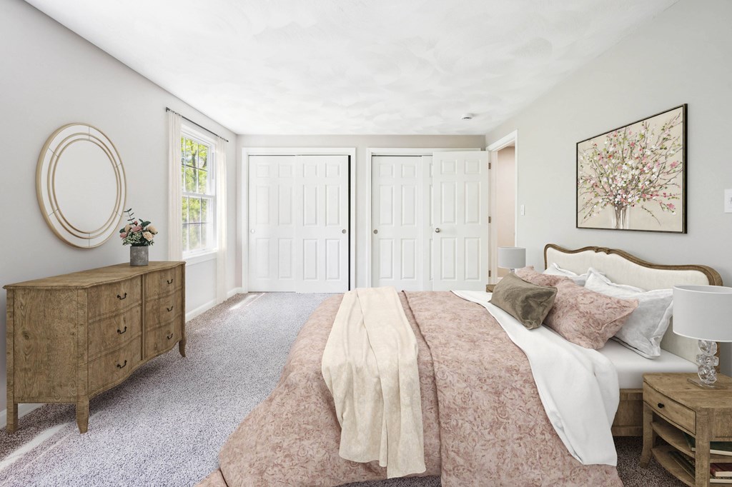 A bedroom with a bed, nightstand, and dresser.