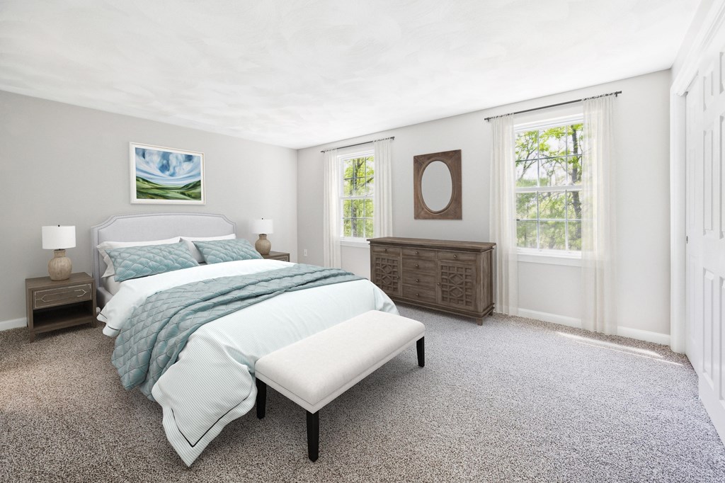 A bedroom with a large bed and a window.