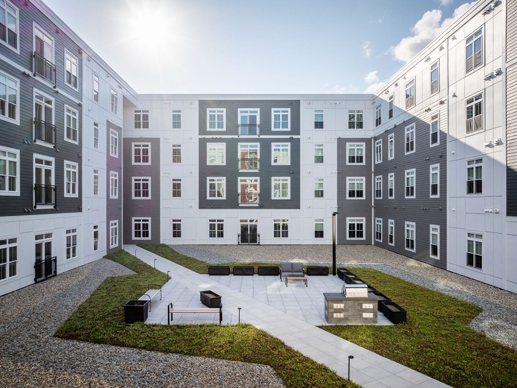 a view of an apartment building with a courtyard