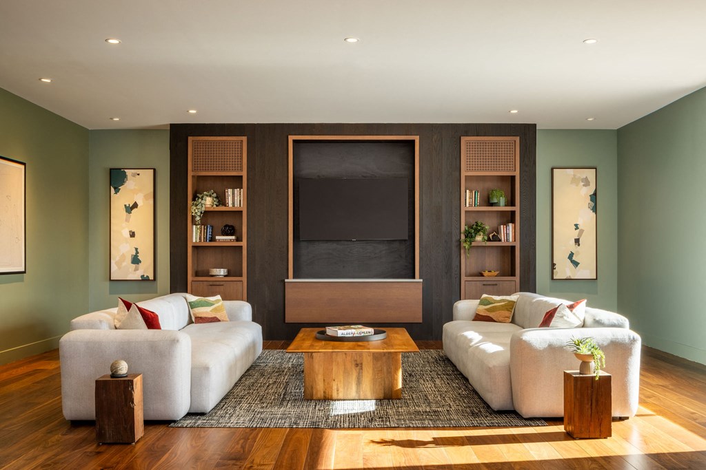 A living room with a white couch, a coffee table, and a fireplace.