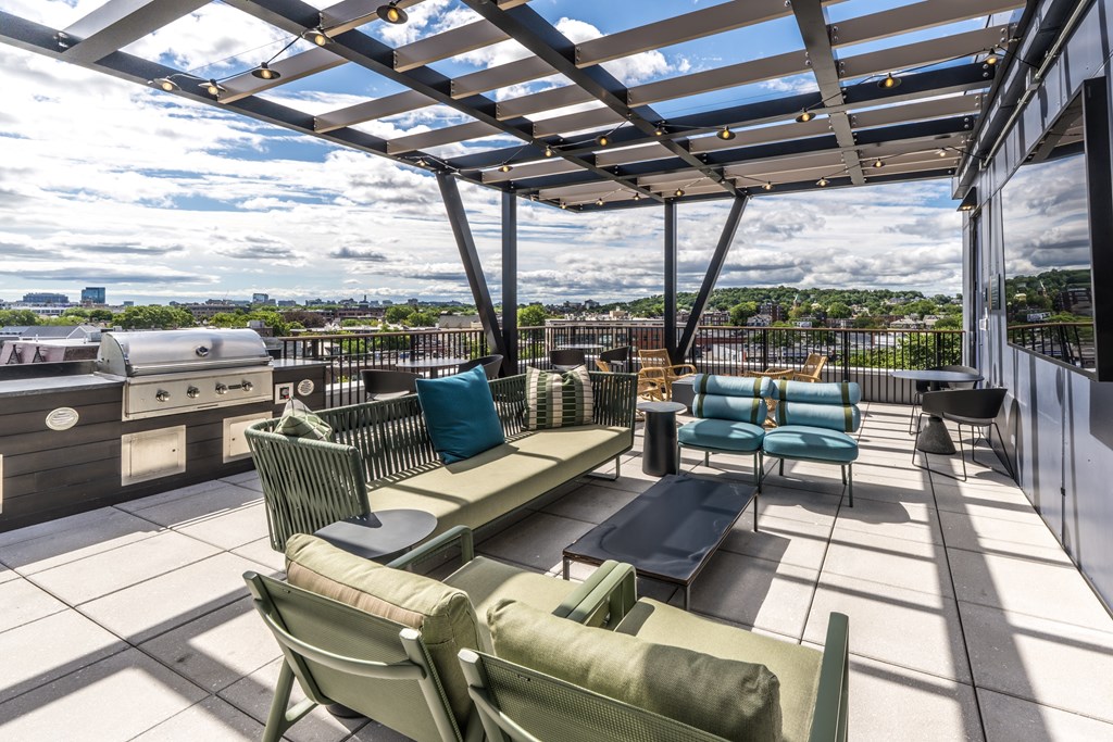 A patio with a table and chairs overlooking a cityscape.