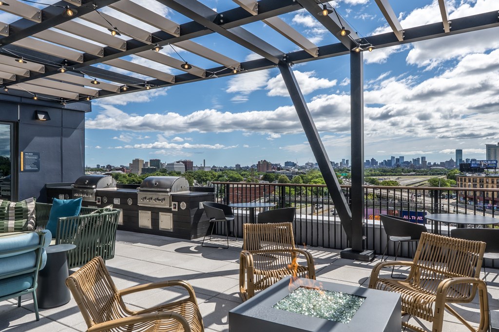 A patio with a table and chairs overlooking a city.