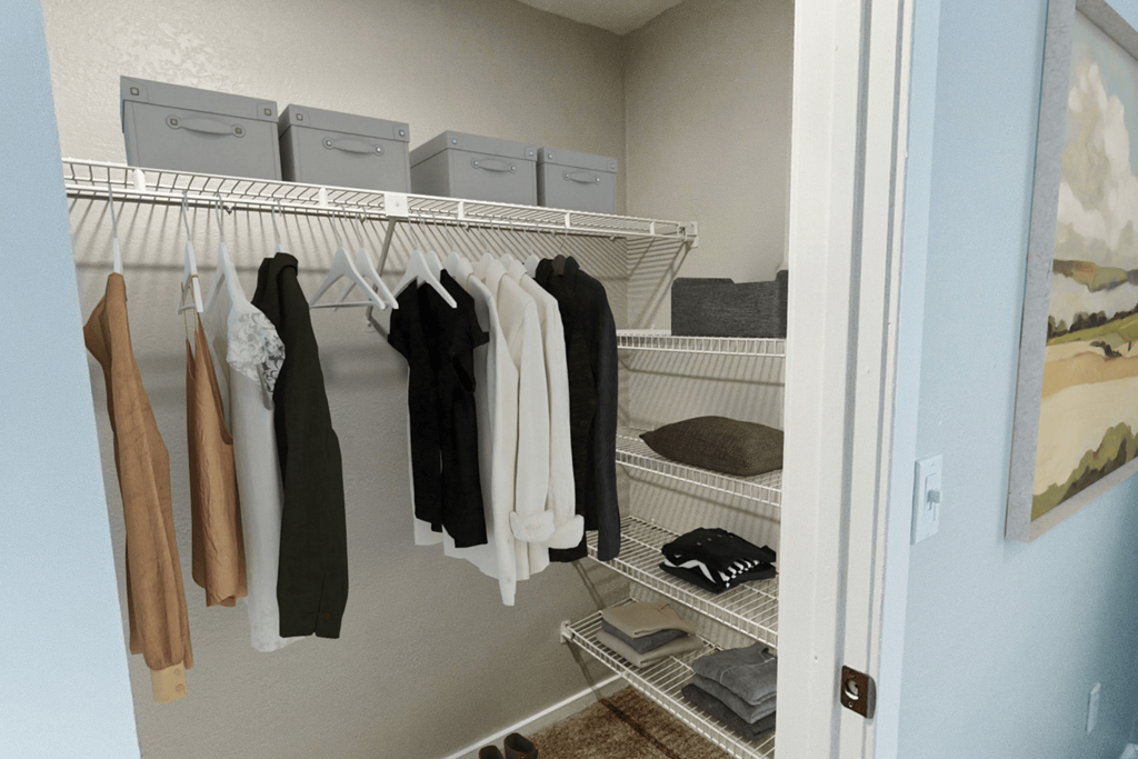 walk in closet with clothes hanging on the racks and folded on shelves at The Meadows, Chelmsford, Massachusetts