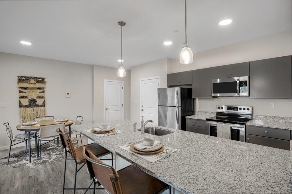Kitchen with bar counter at 21 East Apartments, North Attleboro