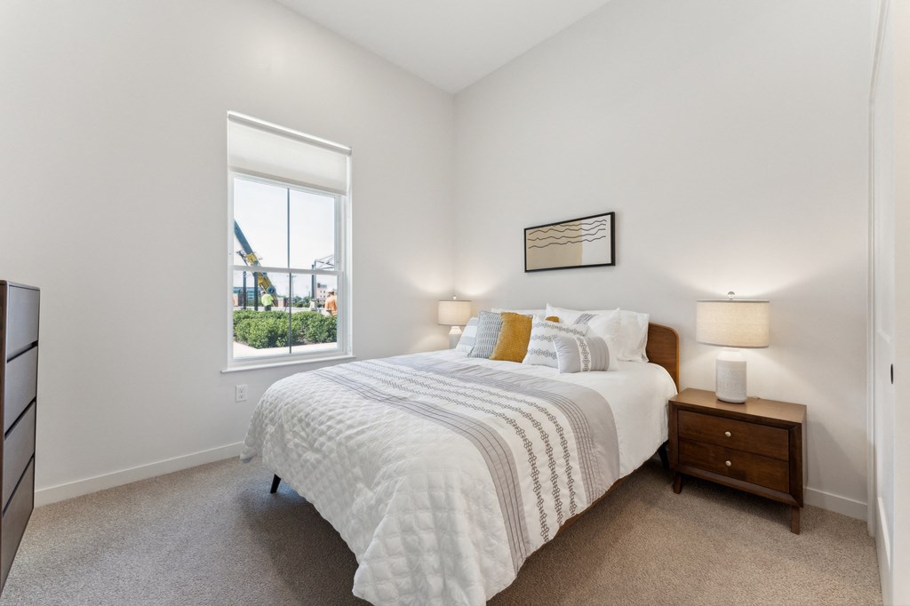 a bedroom with a large bed and a window