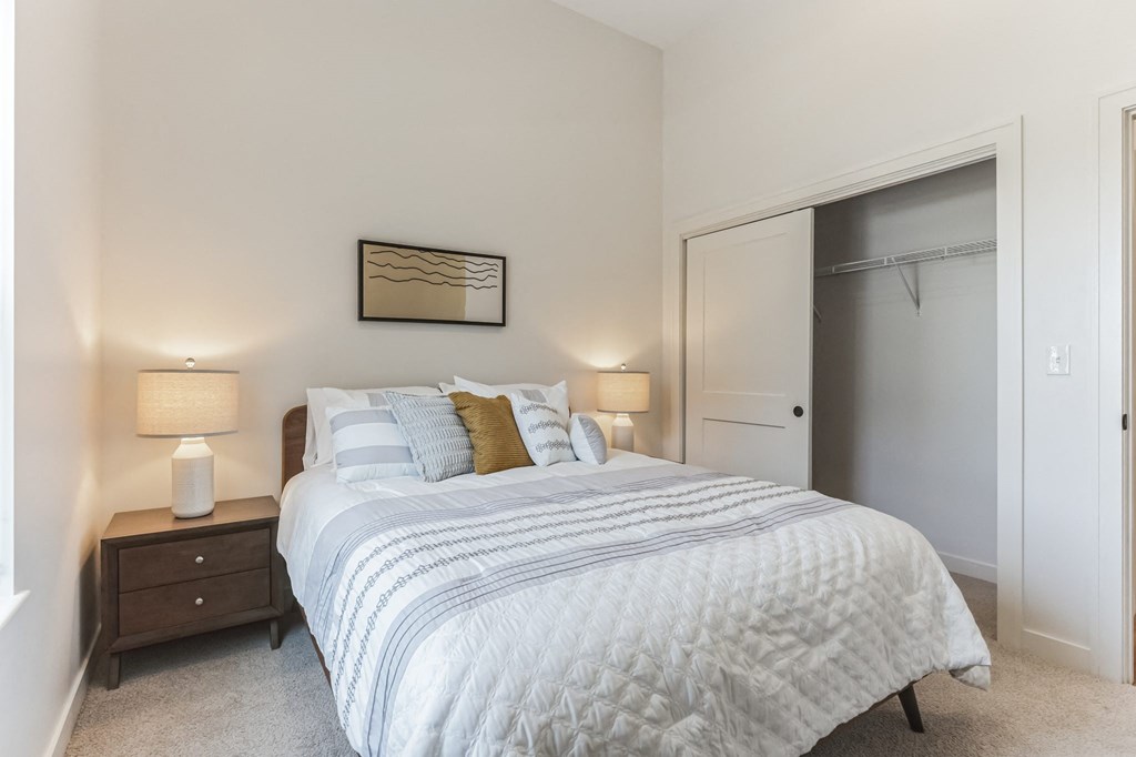 a bedroom with a large bed and a closet