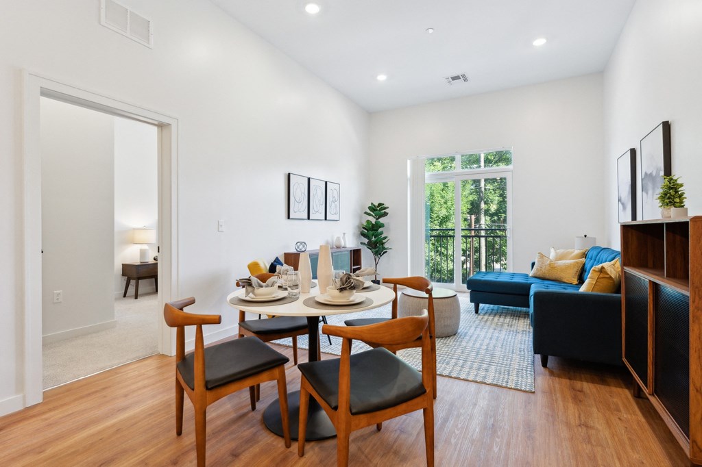 an open living room with a dining room table and chairs