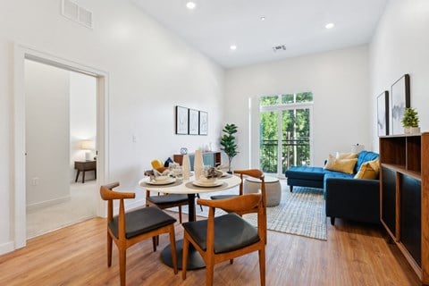 an open living room with a dining room table and chairs